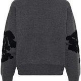 Grey sweater with black accents, shown from behind, photographed against a light background.