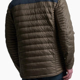 Man wearing a two-tone puffer jacket with a dark blue and brown design on a white background