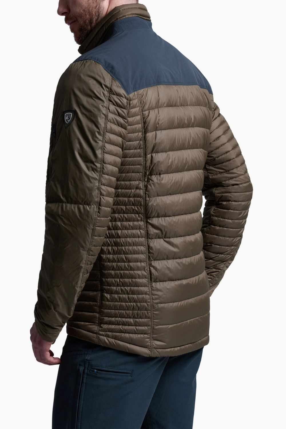 Man wearing a brown puffer jacket with a white background