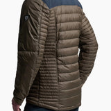 Man wearing a brown puffer jacket with a white background
