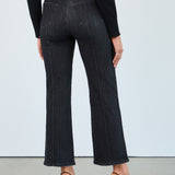 Person wearing black jeans and a black top on a white background