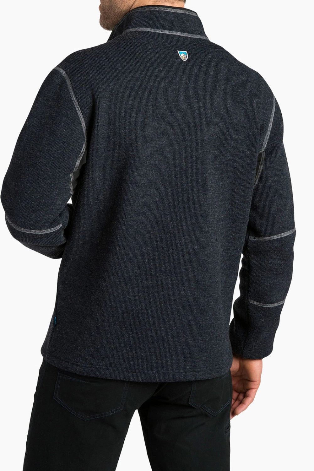 Person wearing a dark gray fleece pullover with a visible brand logo on a white background