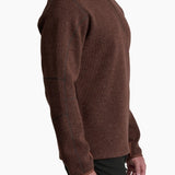 Man wearing a brown turtleneck sweater on a white background