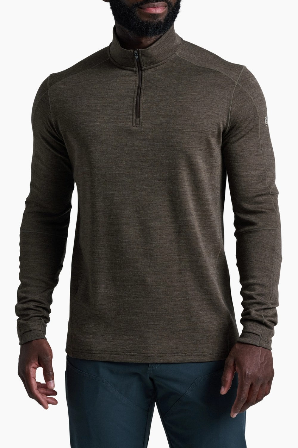 Man wearing a brown long-sleeve shirt with a quarter zip on a white background