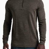 Man wearing a brown long-sleeve shirt with a quarter zip on a white background