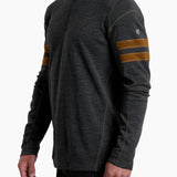 Man wearing a dark gray long-sleeve shirt with brown stripes on the sleeves against a white background