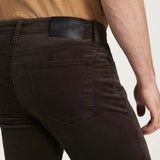 Brown pants worn by a person on a white background