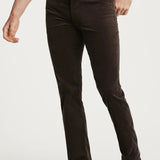 Person wearing brown jeans and brown shoes on a white background