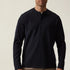 Man wearing a navy long-sleeve shirt against a beige background