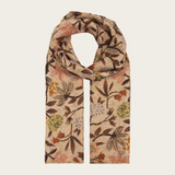 Floral printed scarf  in shades of brown, green and orange photographed on a light backdrop.