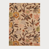 Floral printed scarf  in shades of brown, green and orange photographed on a light backdrop.