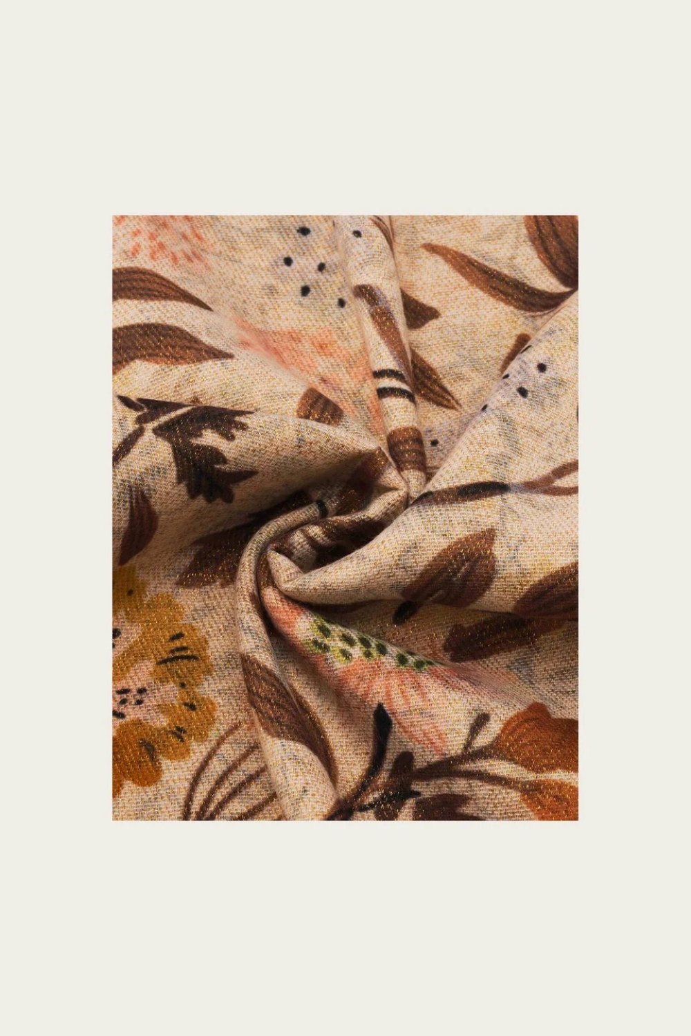Floral printed scarf  in shades of brown, green and orange photographed on a light backdrop.