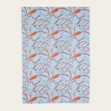 A blue coloured scarf with a brown and grey equestrian print photographed on a light background.