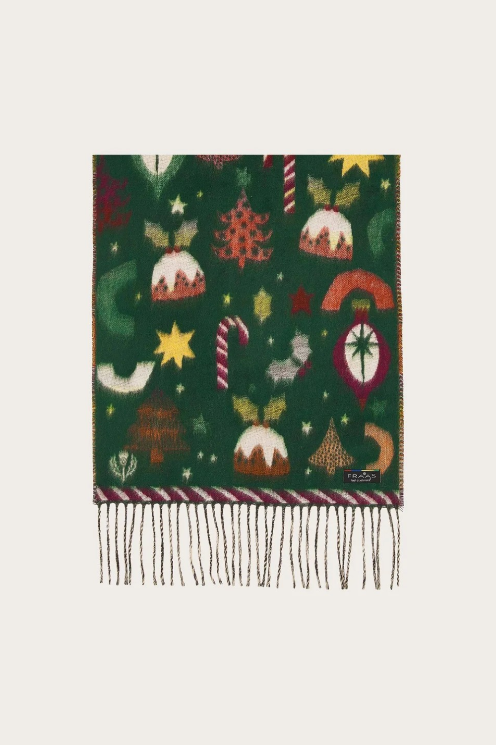 A dark green knit scarf with festive Christmas motifs including candy canes, stars, and trees, finished with fringe at the bottom.