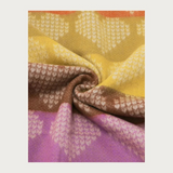 Close up of a multi coloured heart printed scarf photographed on a light background.