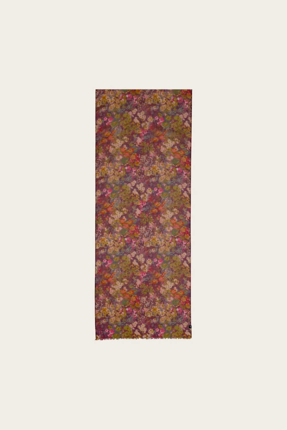 Floral print scarf in shades of burgundy, green, orange and pink photographed on a light backdrop.