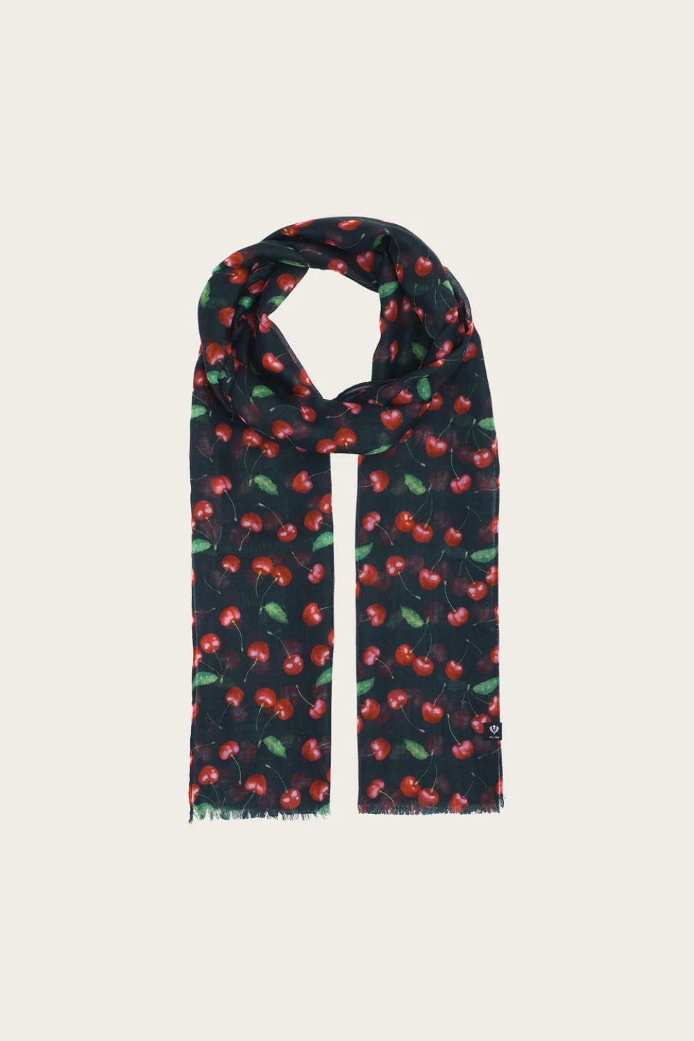 A black base scarf with a cherry print  photographed on a light backdrop.