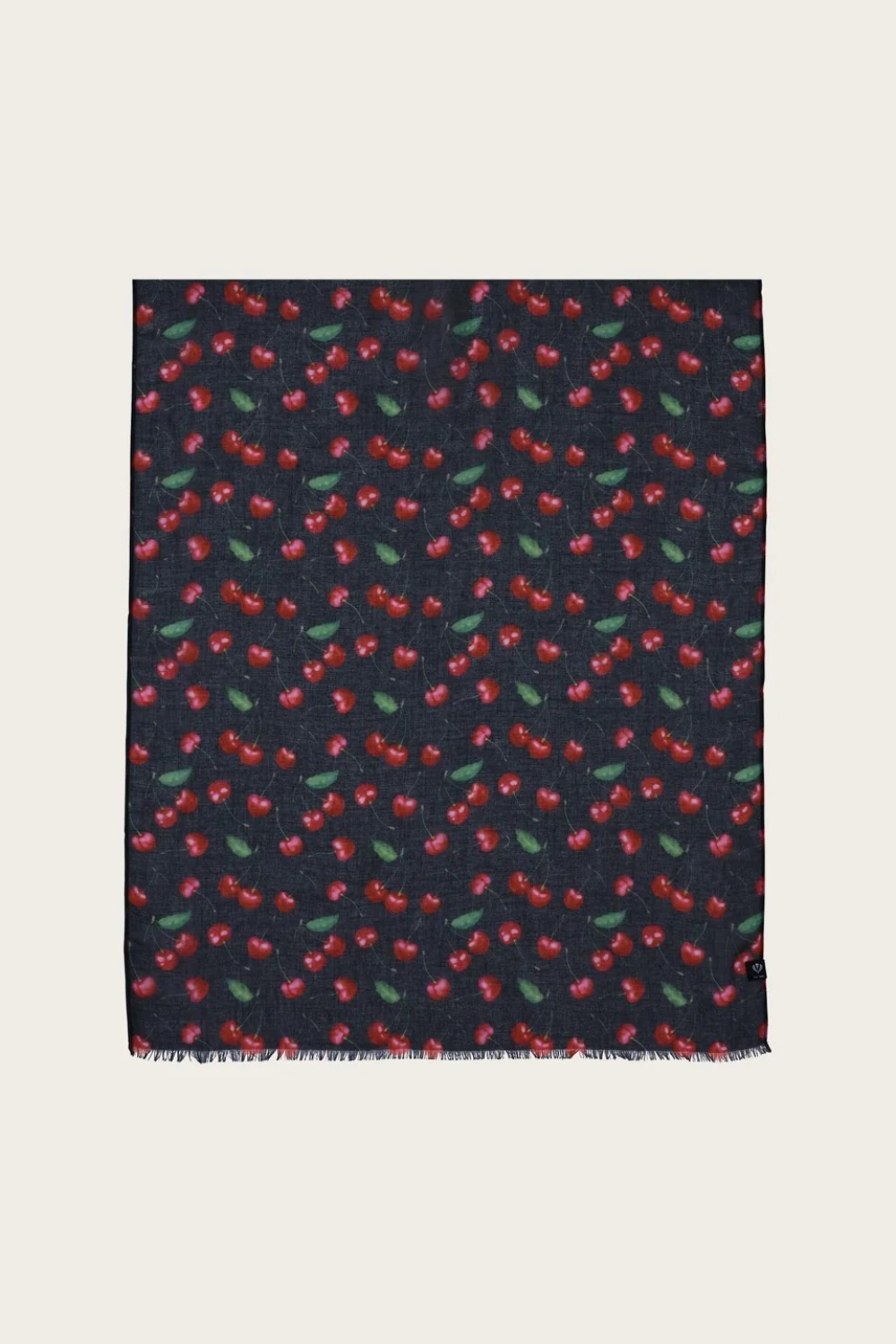 A black base scarf with a cherry print  photographed on a light backdrop.