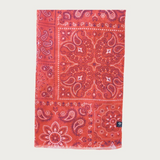 Red paisley scarf photographed on a light background.