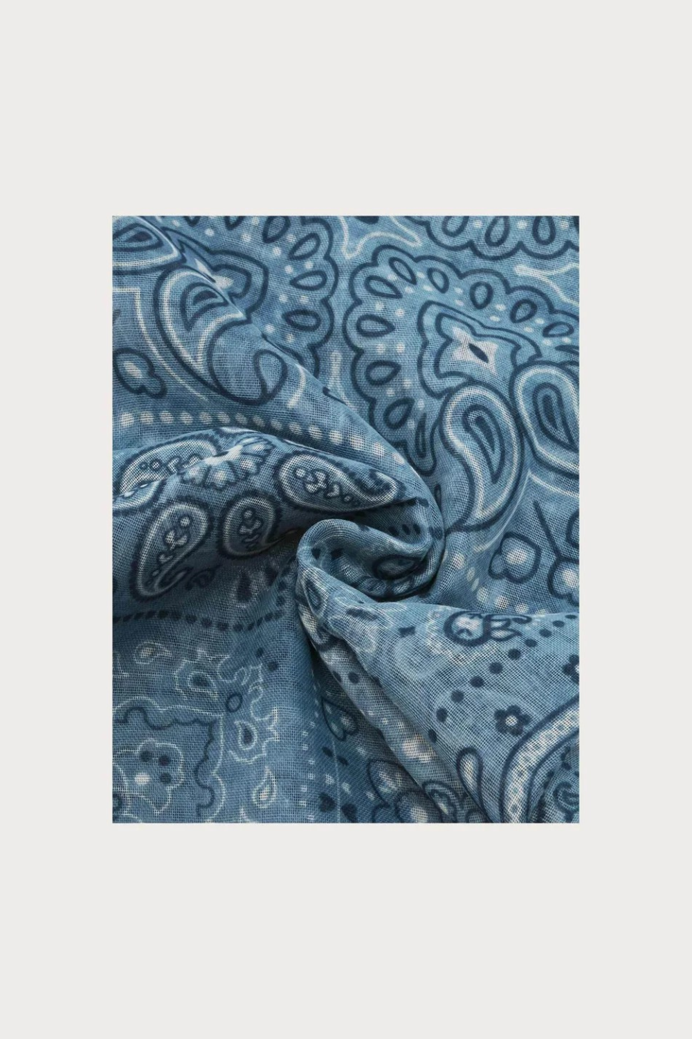 Blue  paisley printed scarf photographed on a light background.