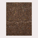 Close up of a brown toque with multi coloured speckles photographed on a light background.