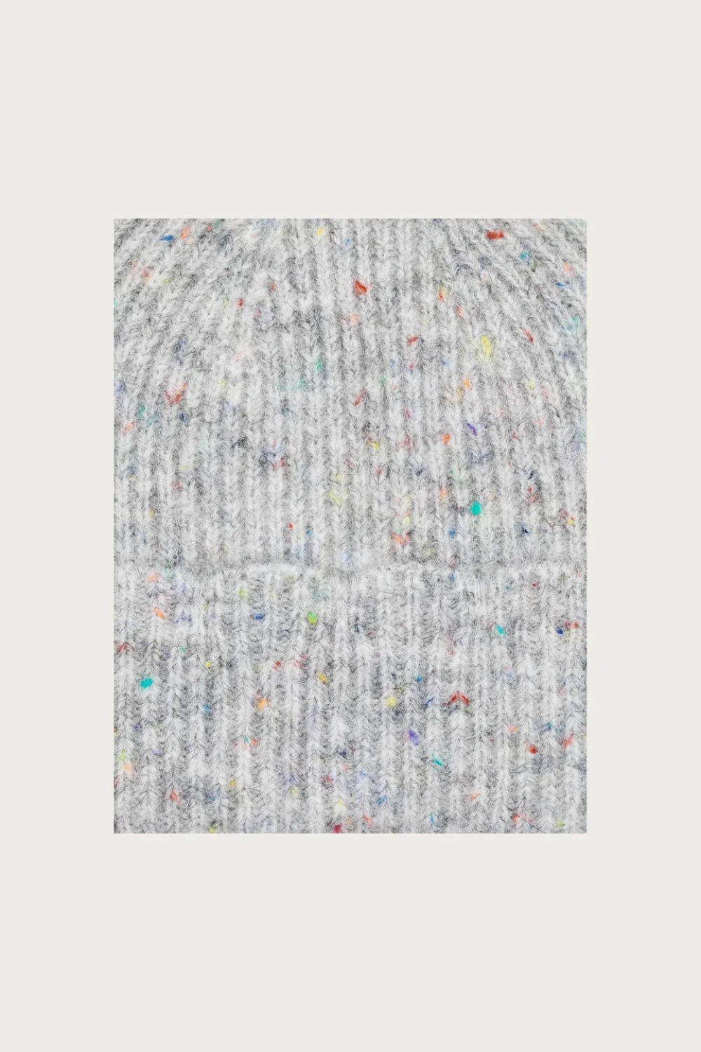 Close up of a grey toque with multi coloured speckles photographed on a light background.