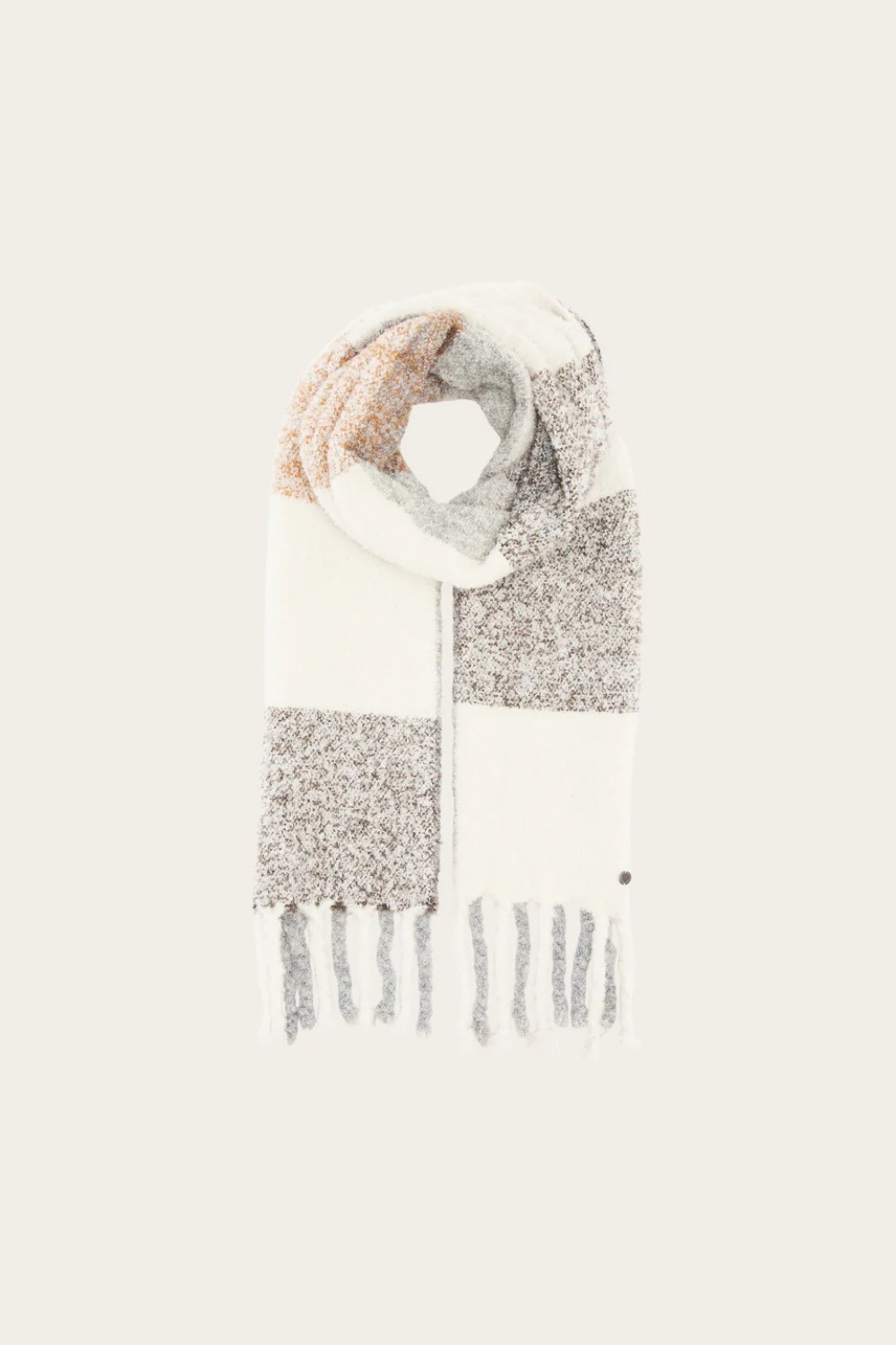 A multi coloured checkered scarf with fringe photographed on a light background.