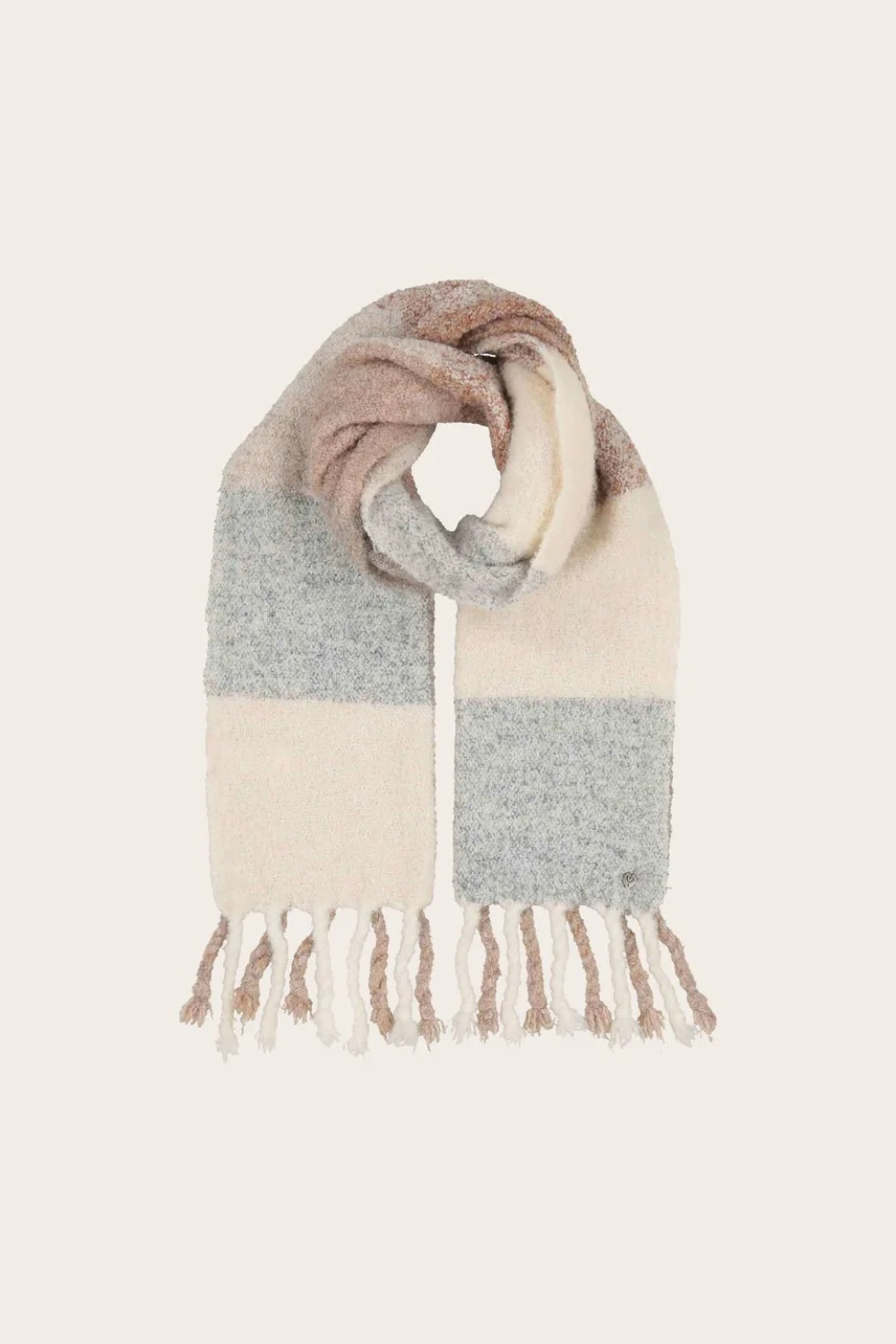 A soft knit scarf with a color-blocked pattern in beige, light gray, finished with fringed tassels, shown on a solid cream background.
