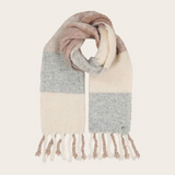A soft knit scarf with a color-blocked pattern in beige, light gray, finished with fringed tassels, shown on a solid cream background.