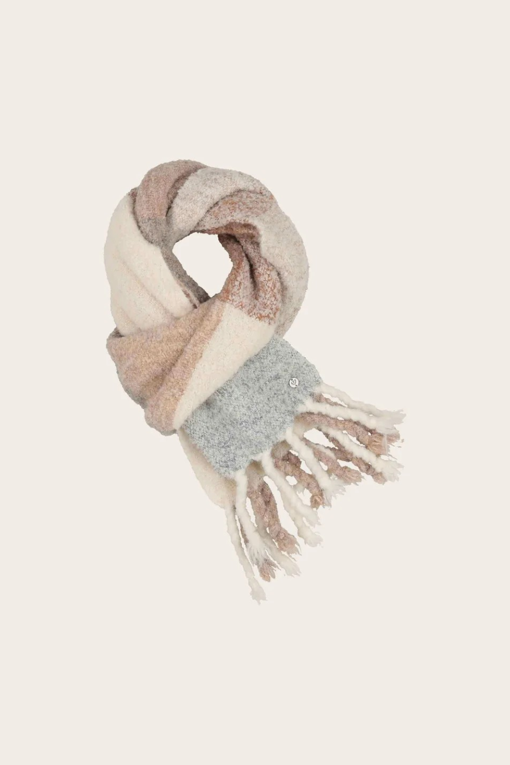 A multi coloured checkered scarf with fringe photographed on a light background.