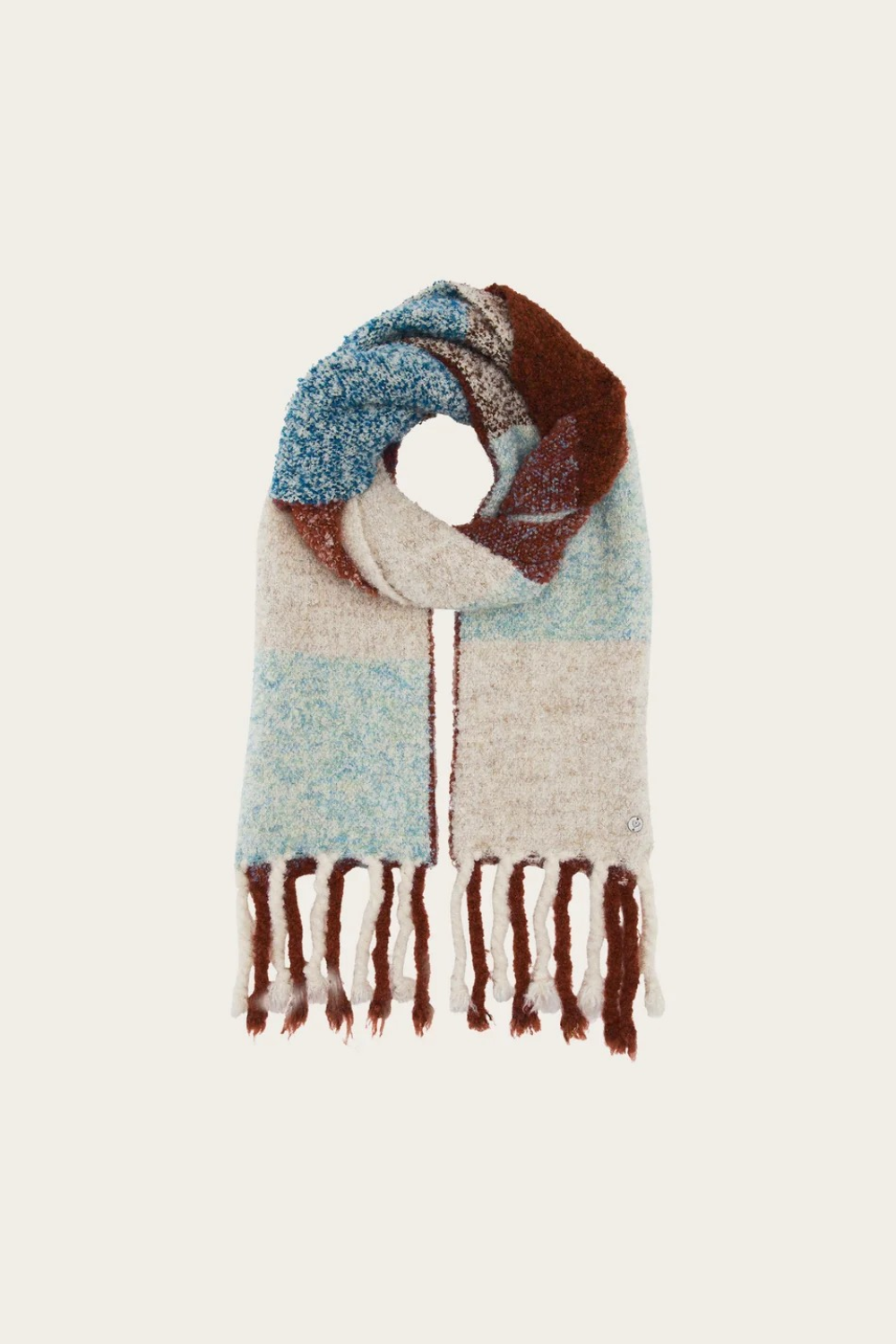A multi coloured checkered scarf with fringe photographed on a light background.