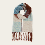 A multi coloured checkered scarf with fringe photographed on a light background.