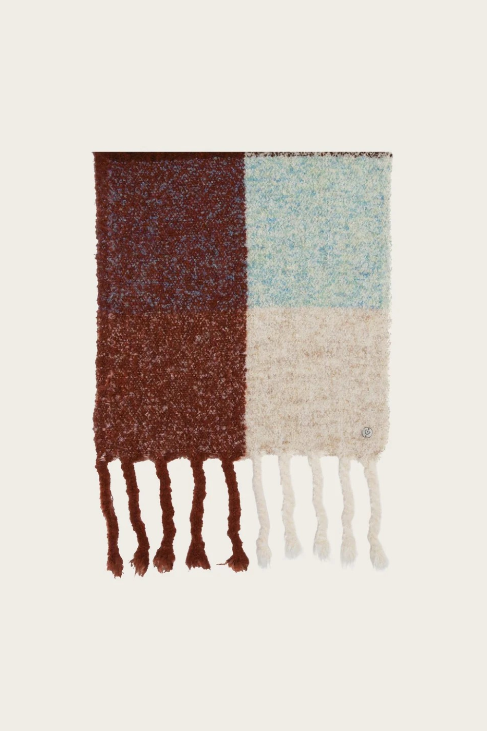A multi coloured checkered scarf with fringe photographed on a light background.