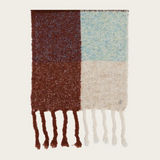 A multi coloured checkered scarf with fringe photographed on a light background.