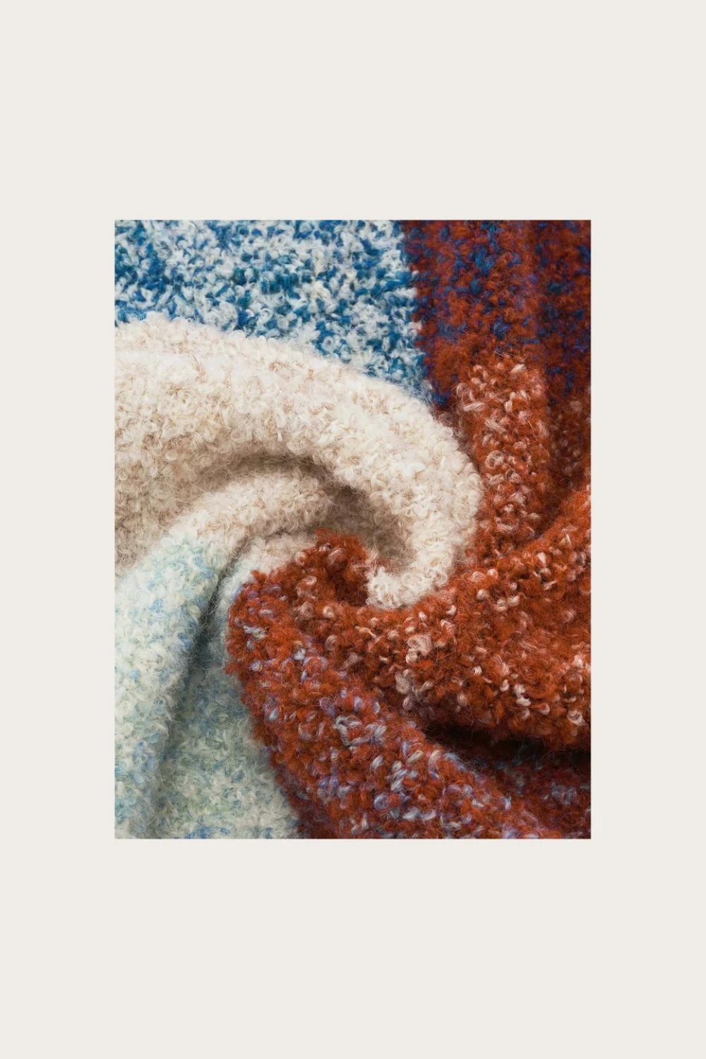 Close up of a multi coloured checkered scarf photographed on a light background.