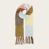 A multi coloured checkered scarf with fringe photographed on a light background.