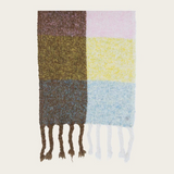 A multi coloured checkered scarf with fringe photographed on a light background.