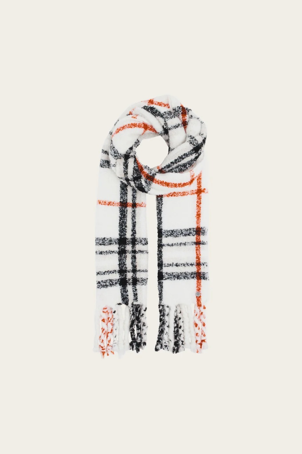 A cream, black and orange plaid scarf with fringe photographed on a light background.