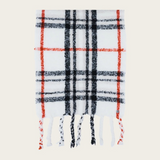 A cream, black and orange plaid scarf with fringe photographed on a light background.