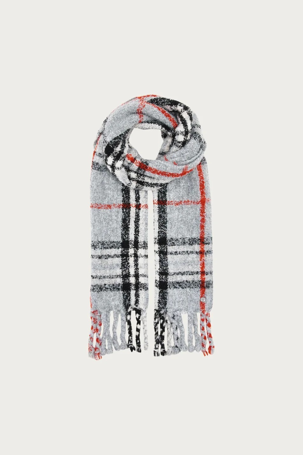 A grey, black and orange plaid scarf with fringe photographed on a light background.