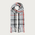 A grey, black and orange plaid scarf with fringe photographed on a light background.