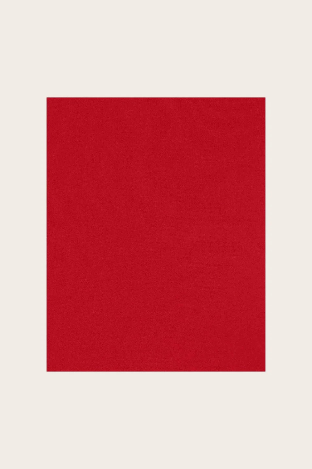 Red fabric photographed against a light background.