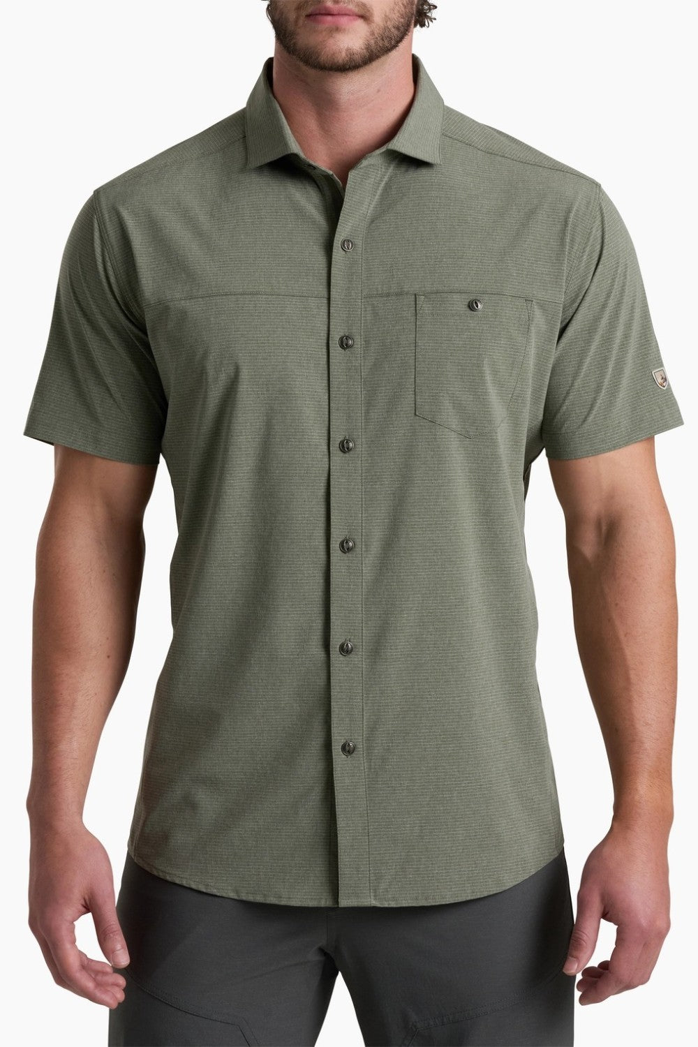 Man wearing a green short-sleeve button-up shirt on a white background