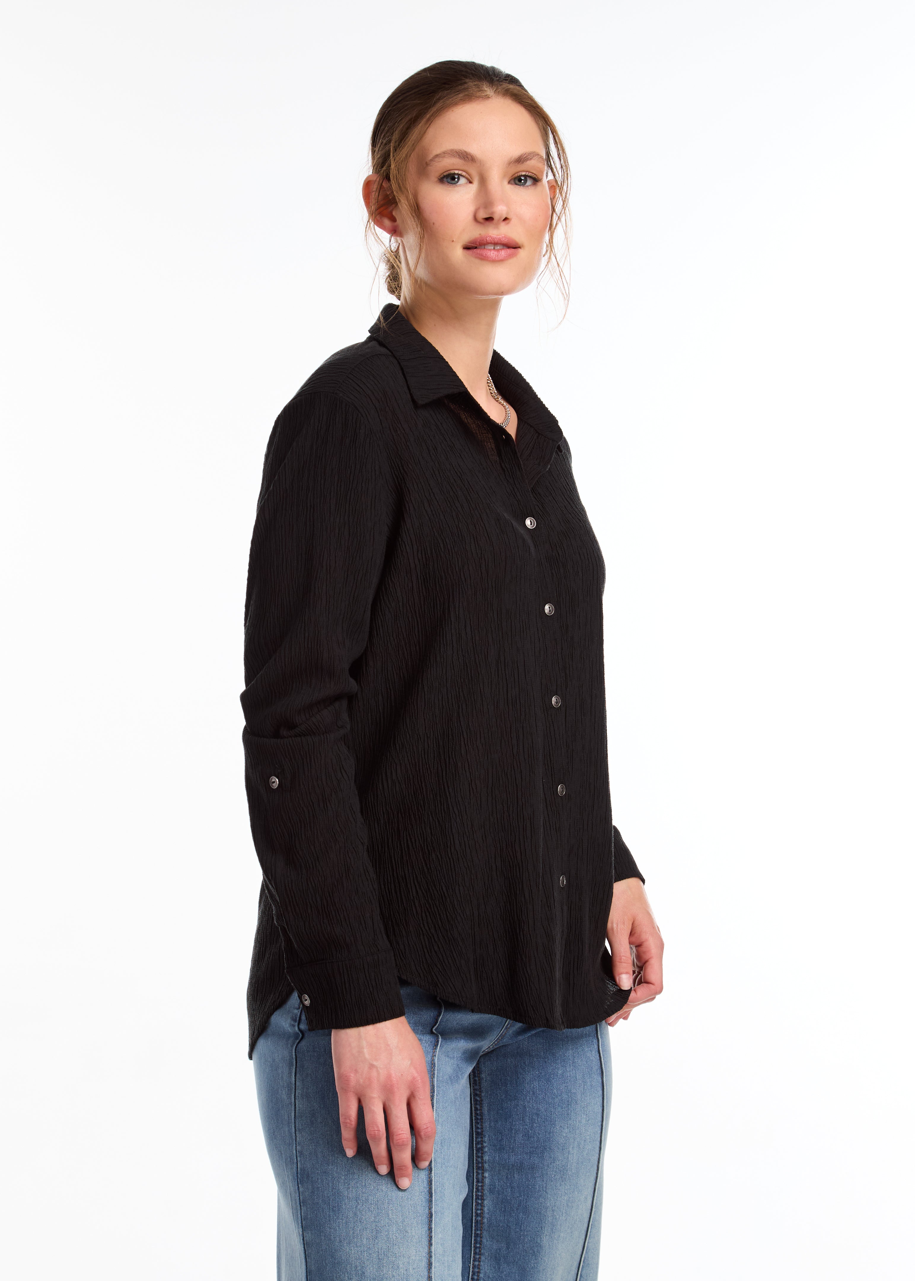 Introducing the FDJ Long Sleeve Roll Up Crinkle Shirt. This solid black shirt features a full button front and a traditional collar. The roll tab sleeves add a touch of versatility, making this shirt perfect for most occasions. Stay stylish and comfortable with FDJ.