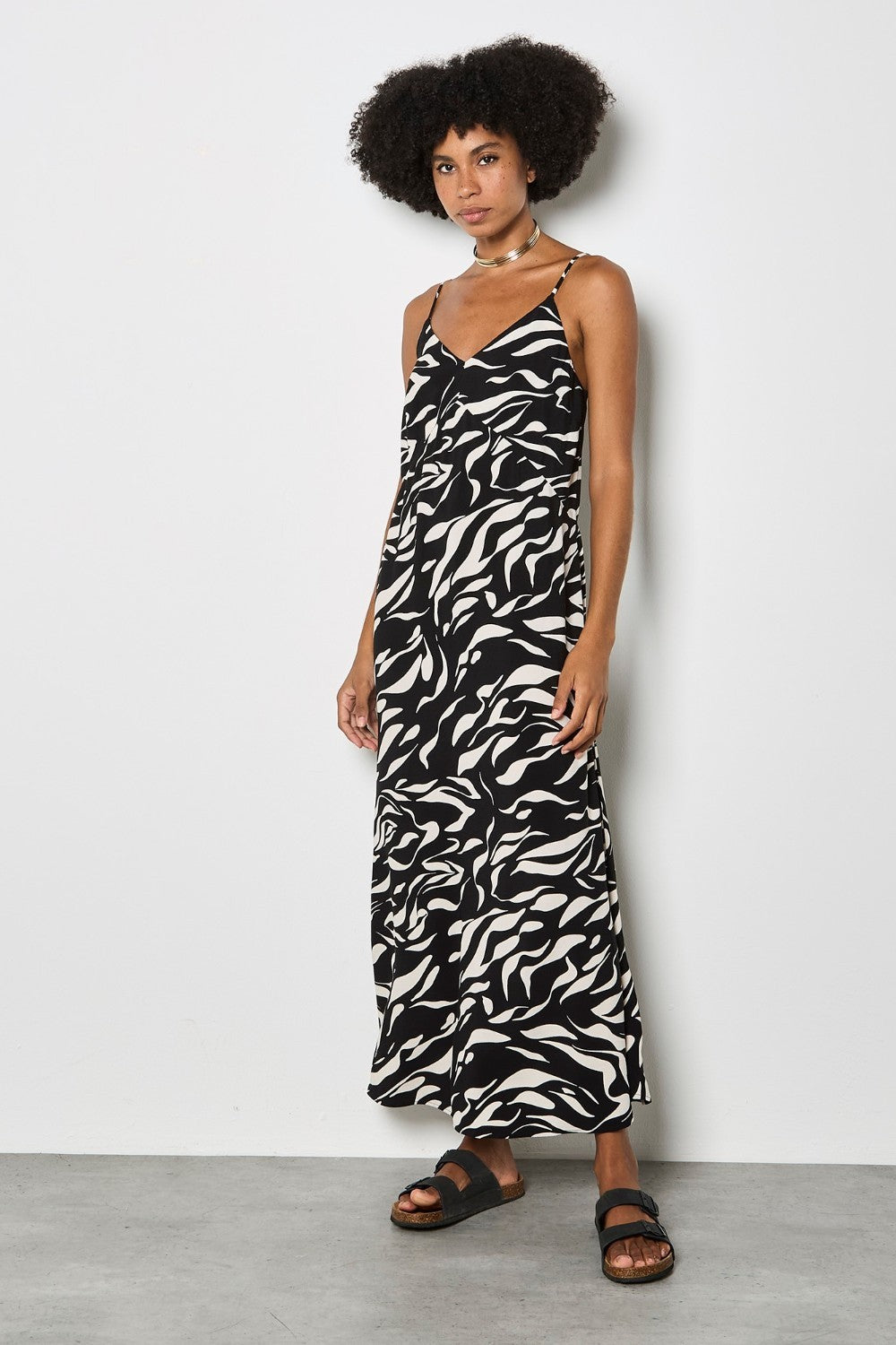 Woman wearing a zebra print dress against a white background