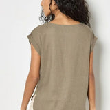 Woman wearing a green t-shirt against a white background