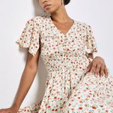 Woman wearing a floral dress against a white background