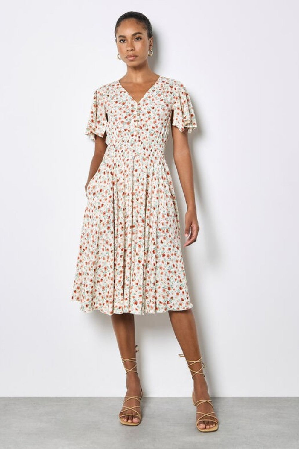 Woman wearing a floral dress against a white background