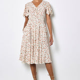 Woman wearing a floral dress against a white background