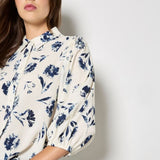 Add feminine florals to your weekly rotation with this pressed daisy print shirt. Designed in a soft, woven fabric, it features a collar, a button-down front, and cropped balloon sleeves. Keep this floral shirt casual with light-wash denim, or style it with tailored trousers and loafers for an office to off-duty look.